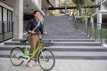 Young Asian businessman Go to work by cycling to reduce air pollution and stay healthy.