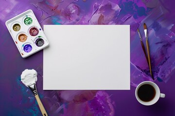 a paper and paintbrushes on a purple surface