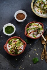 Homemade Dahi Vada - North Indian chat  lentil fritters dunked in yogurt topped with sweet and spicy chutneys