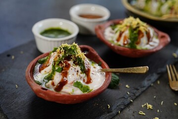 Homemade Dahi Vada - North Indian chat  lentil fritters dunked in yogurt topped with sweet and spicy chutneys