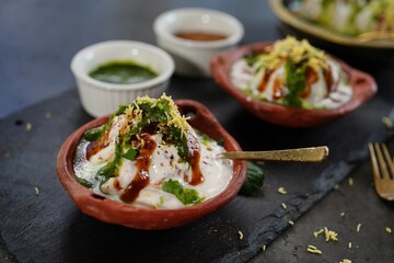 Homemade Dahi Vada - North Indian chat  lentil fritters dunked in yogurt topped with sweet and...