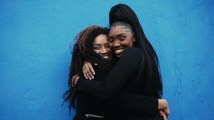 African American Adolescent daughter hugs mother in genuine affectionate love. Caring moment...