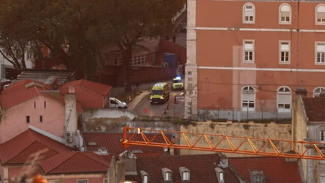 INEM ambulance in an emergency mission, 4k video view from above on streets of Lisbon city. Integrated Medical Emergency System also called INEM in Portugal.