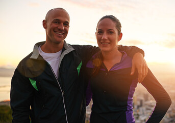 Happy couple, portrait and fitness with hug in sunset on mountain for workout, exercise or training together. Man and woman with smile, love or support for hiking, running or health and wellness