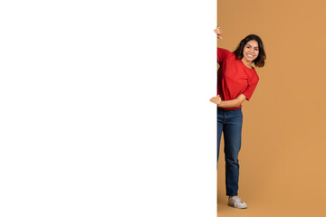 Arab woman posing next to huge advertising board