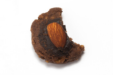 Broken of afghan cookies made from chocolate and cornflakes with almond on top isolated on white...