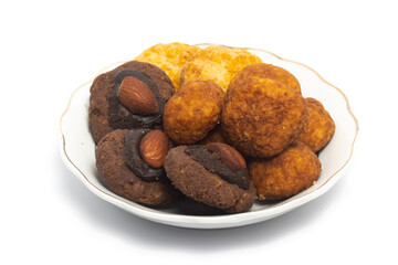 Assorted cookies of palm cheese and cornflakes and afghan cookies in a small white plate isolated on white background clipping path