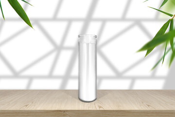 Classic candle in glass mockup empty shelf with light and window- shadows with fresh leaves border