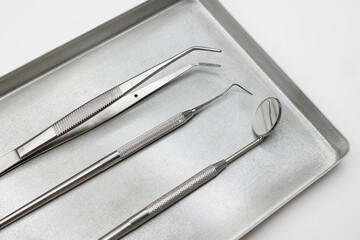 Dental instruments, forceps close up ,set of tools isolated on white, set of metal dental instruments. Dental extraction forceps.