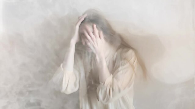 Artistic video of an obscured female figure expressing distress amidst ethereal smoke, conveying a concept of mental health or inner turmoil, suitable for projects related to emotional struggle or psy
