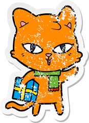 distressed sticker of a cartoon cat with a present