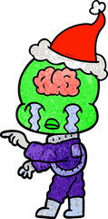 textured cartoon of a big brain alien crying and pointing wearing santa hat