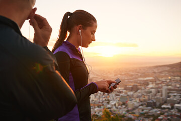 Couple, fitness and music with phone in sunset for podcast, radio player or sound on mountain. Man...