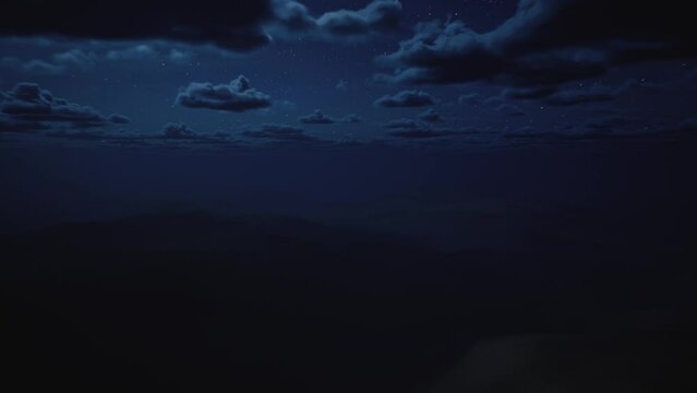 AERIAL view of epic desert landscape with, night to day time changing. Moon going down and sun rising. Clouds moving fast above huge desert dunes.