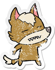 distressed sticker of a cartoon wolf waving showing teeth