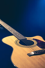 Fototapeta premium Musical background with acoustic guitar close up.