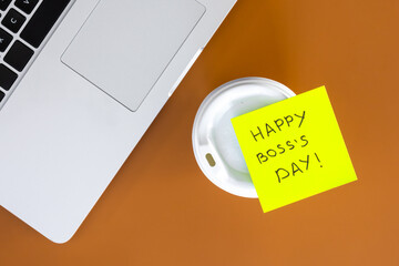 Sticky note with phrase Happy Boss Day attached to cup of coffee, flat lay.