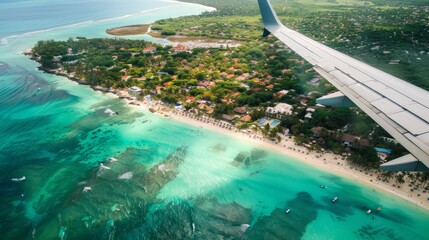 Airplane wing view over tropical beach, turquoise water