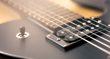 Photo of details of an electric guitar close up.