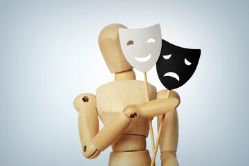 Wooden mannequin with two masks showing different emotions - Concept of psychology, mood change and bipolar disorder - 751475062
