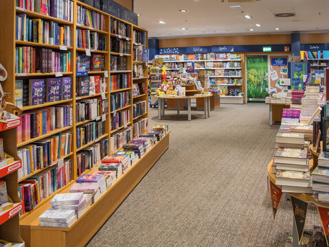 Wolfsburg, Germany &ndash; January 20, 2024: Different colorful books lying on the shelves in the modern urban bookshop, Bookstore Thalia, bookshelves filled with books, hobby, reading