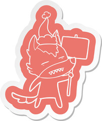 cartoon  sticker of a wolf with sign post showing teeth wearing santa hat