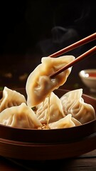 Chinese Dumplings with Chopsticks and Sauce
