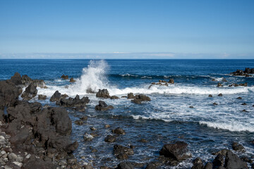 Laupahoehoe Point Beach wave that is smashing against a rock