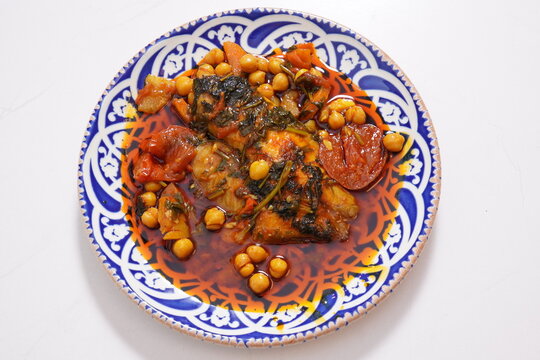 Moroccan dish  with fish and vegetables in red gravy