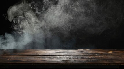 On a black background, an empty wooden table with smoke floats up. Empty space for displaying your products, with a smoke float up on a dark background. Space available for displaying your products