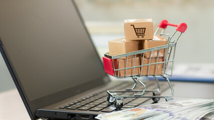 Boxes in a trolley on a laptop keyboard. Ideas about online shopping, online shopping is a form of...