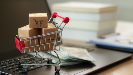 Boxes in a trolley on a laptop keyboard. Ideas about online shopping, online shopping is a form of electronic commerce that allows consumers to directly buy goods from a seller over the internet.