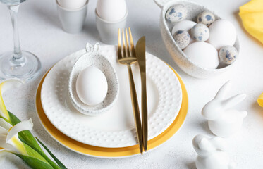 Festive elegant white with yellow Easter table setting Close up.