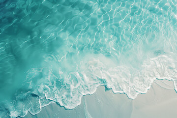 Fototapeta na wymiar crystal blue water as ocean ripples over sand at beach