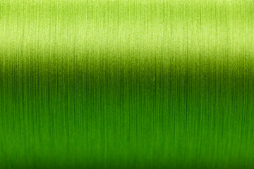 Closed up of green color of thread textured background (Focus at center of picture)