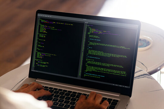 Developer programmer writing html javascript code in a laptop. Close up view.