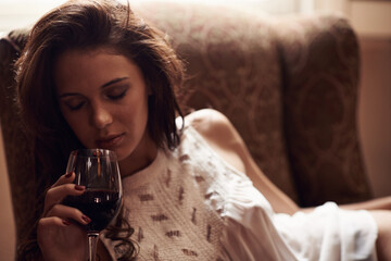 Woman, couch and wine to relax at home, alcohol and natural ambient light with eyes closed....