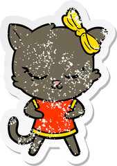 distressed sticker of a cute cartoon cat with bow