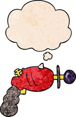 cartoon ray gun and thought bubble in grunge texture pattern style