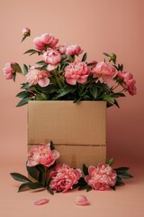 Peonies in delicious shades of pink overflow from a plain cardboard box, suggesting abundance