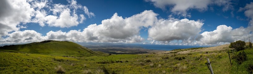 Fototapeta premium Panoramic view of a landscape of big island with big clouds