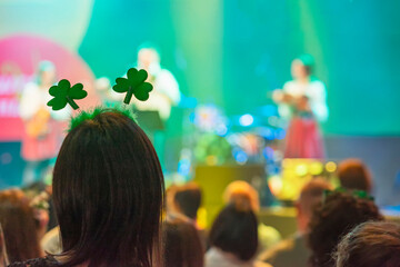 Rear view of woman with green Clover head decoration on head, Saint Patrick's Day celebrating