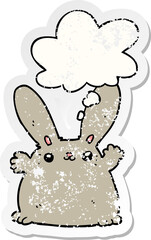 cartoon rabbit and thought bubble as a distressed worn sticker