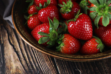 A bowl with ripe bright strawberry in rustic style	