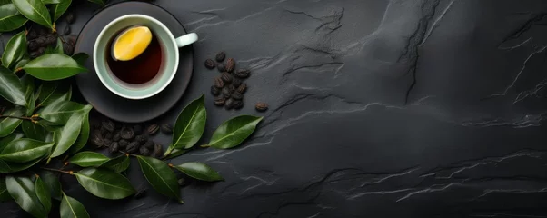 Fotobehang Cup of hot tea and tea leaves on dark luxury stone background, banner. Generative Ai. © annamaria