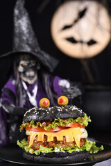  Monster Burger. Black bun, juicy beef cutlet, lettuce, onion, tomato and cheese in the shape of teeth, eyes with olives. Definitely a pick-me-up and a perfect Halloween party appetizer.