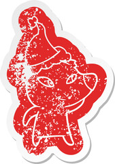 cute cartoon distressed sticker of a bear wearing santa hat