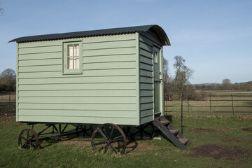 rustic green shepherds hut in the countryside