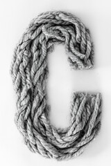 Letter C made from gray threads isolated, top view.