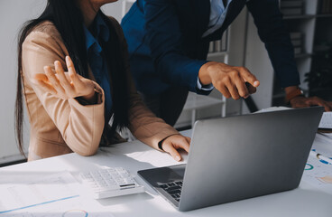 Obraz premium Business team working with new startup project plan and discussion information for financial strategy with laptop and digital tablet in a modern business lounge.